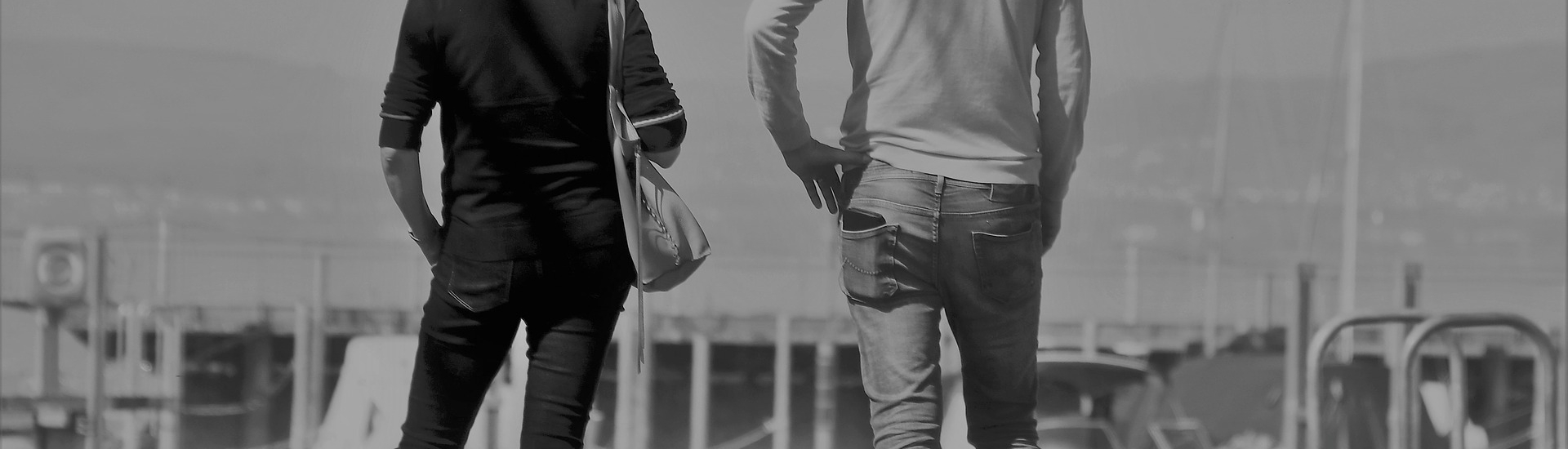 Couple stand together watching boats in a dock