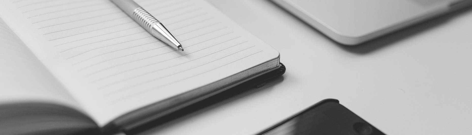 Laptop, phone and notepad