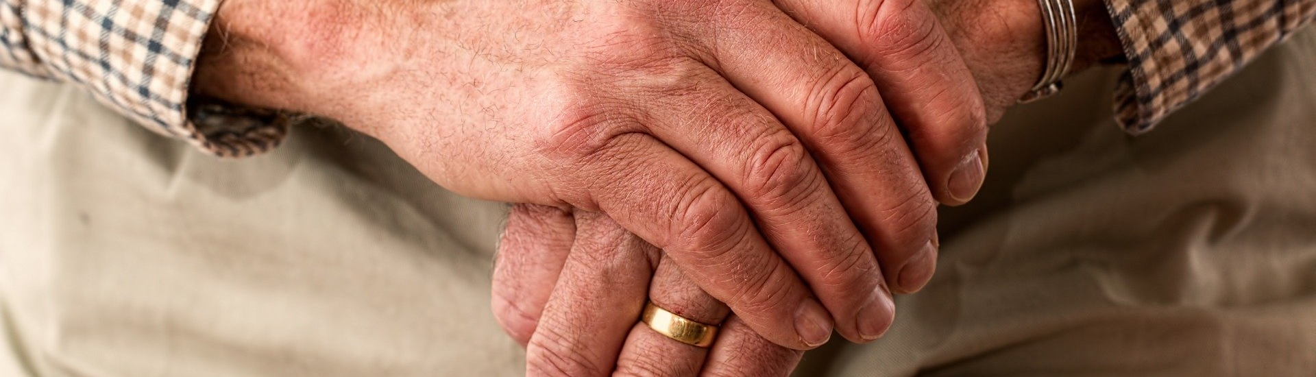 Old mans hands with wedding ring