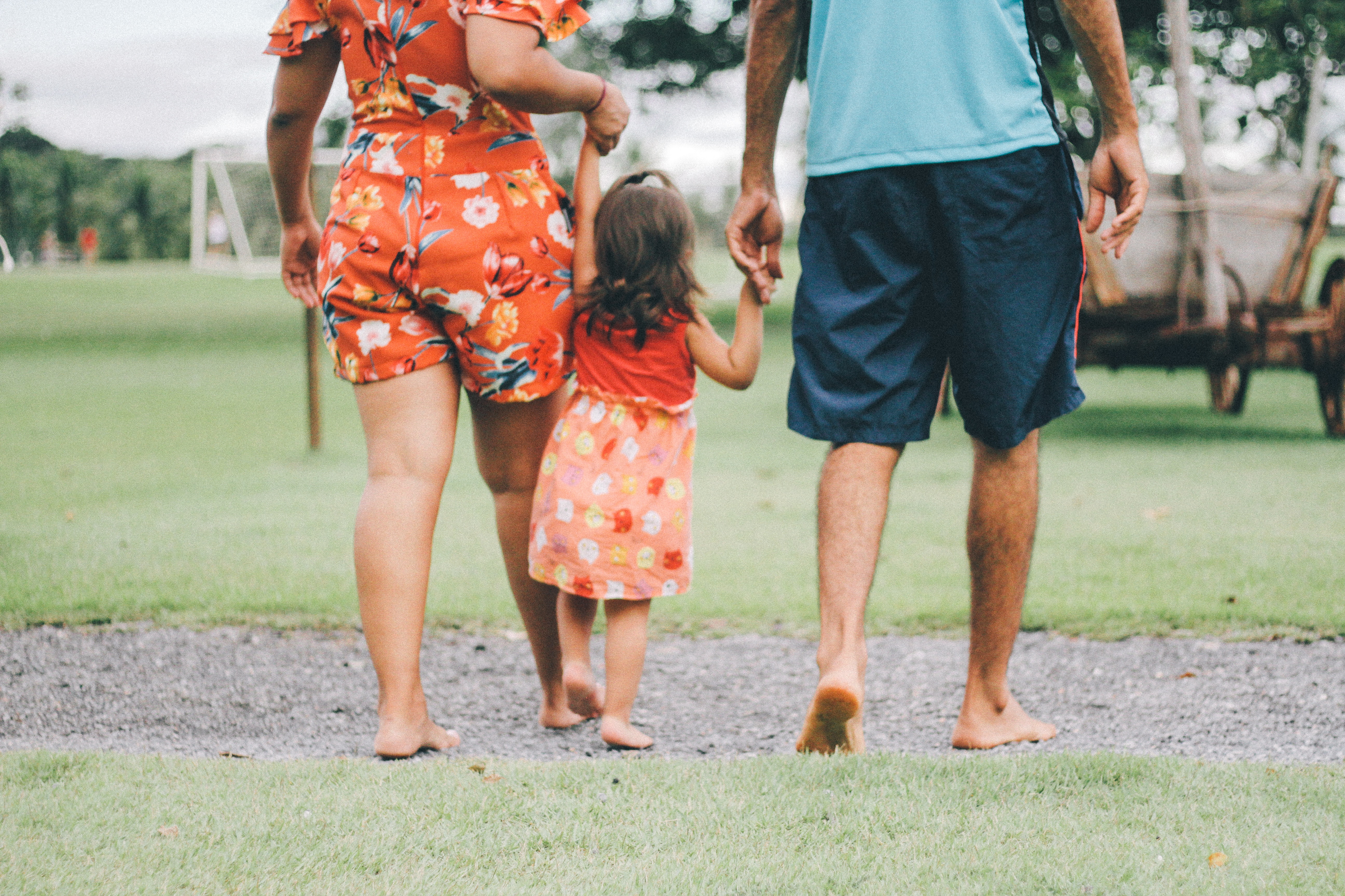 A couple hold hands with a toddler