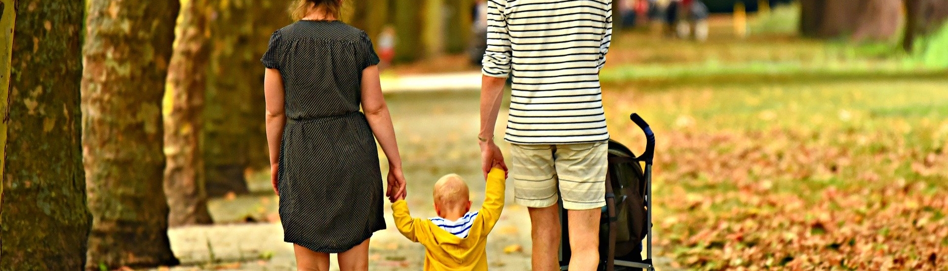 Young couple walk with toddler