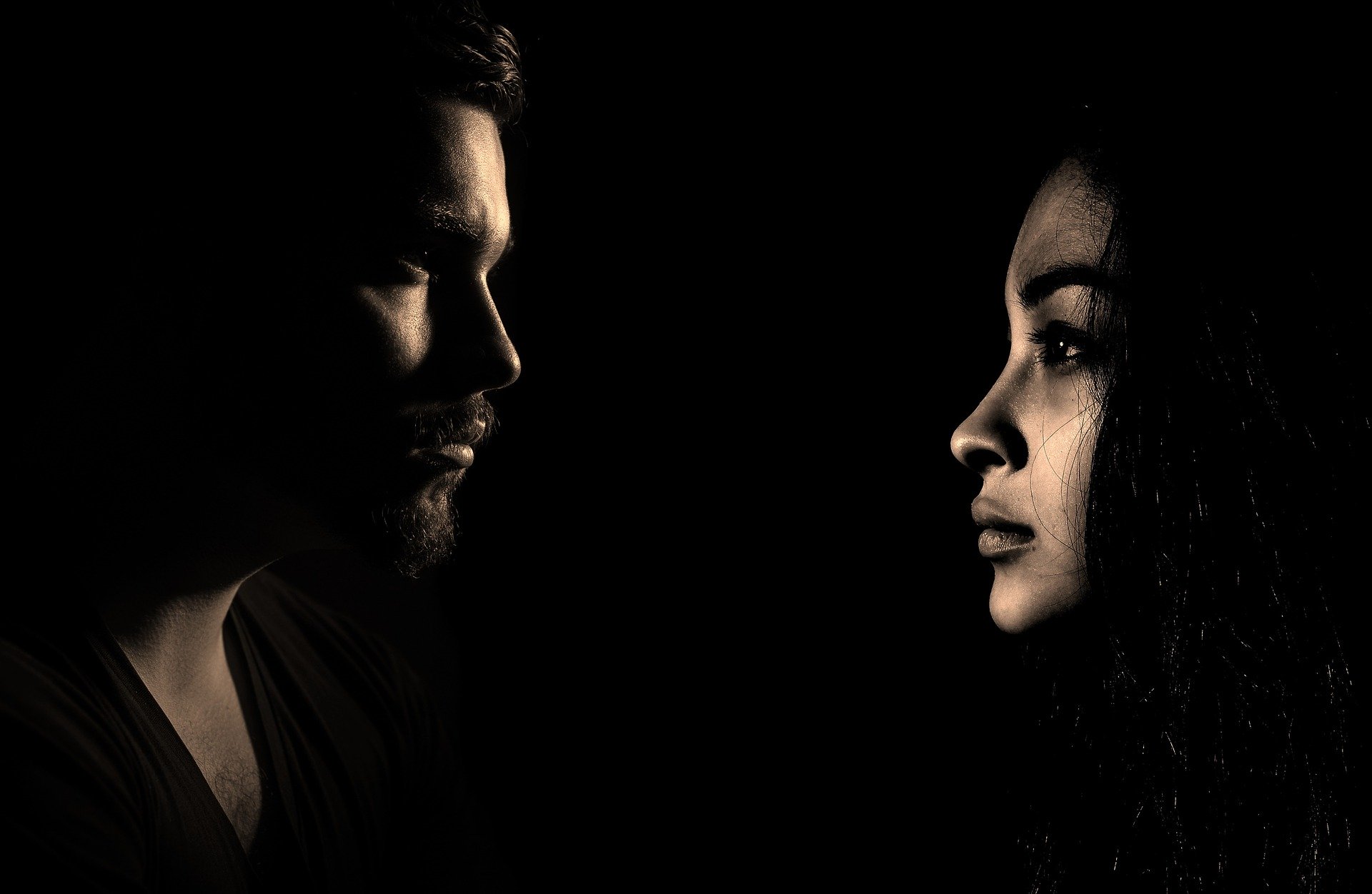 Image of a man and woman looking serious with dramatic lighting