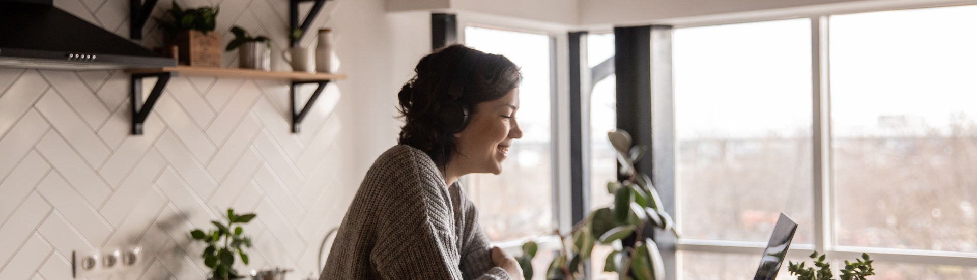 Middle aged woman on video call in kitchen